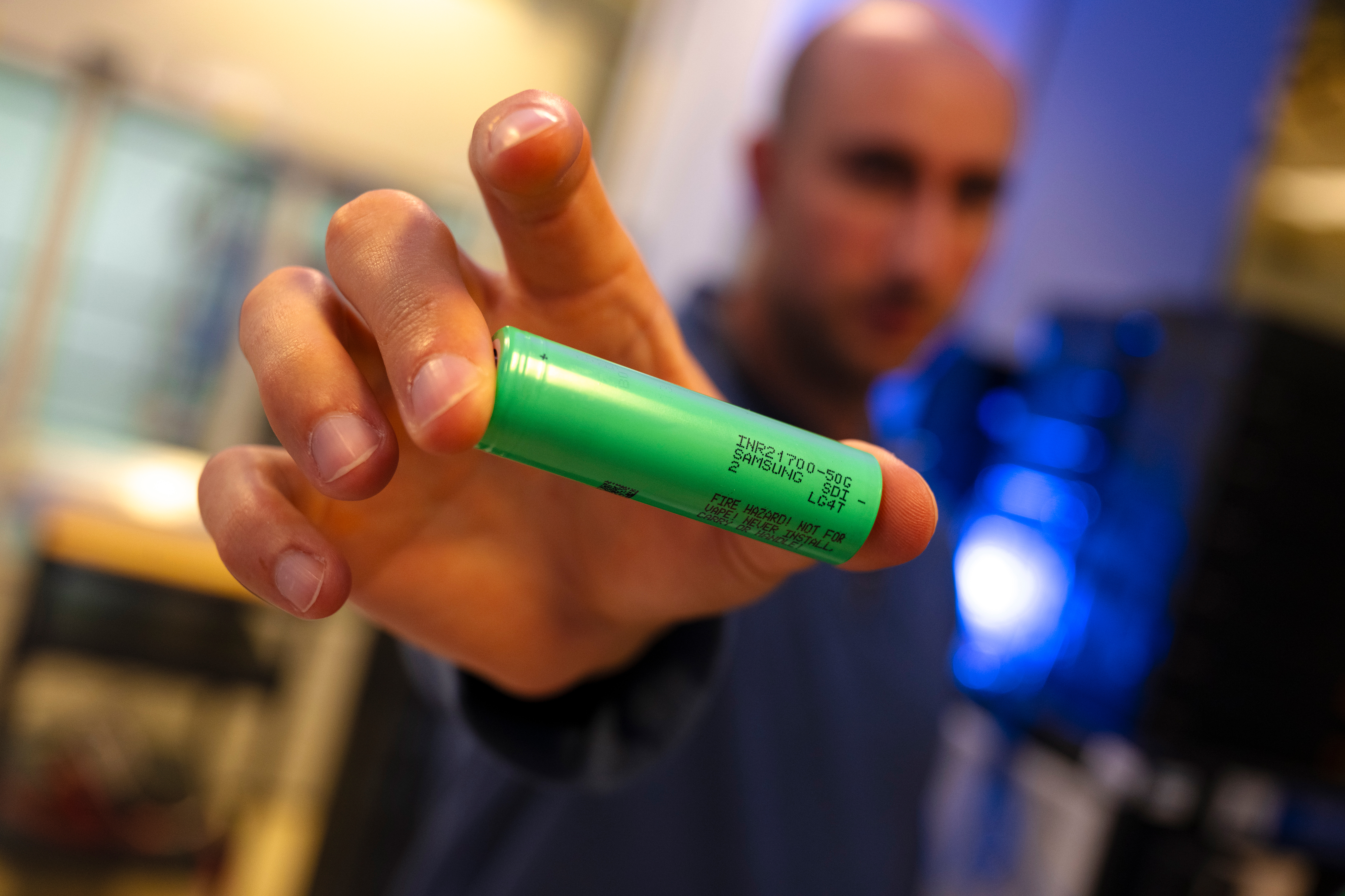 Team member holds battery with rack focus. 